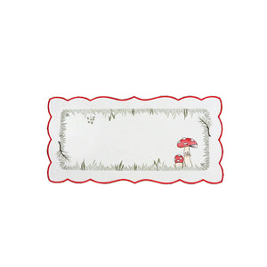 White table runner with scalloped edges, and an outer red border. An interior border design depicts mushrooms in a field, with twigs, grass, and other forest foliage.