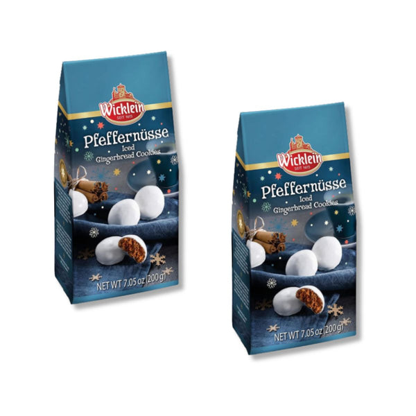 Two packages of Wicklein Pfeffernüsse (gingerbread cookies) on a plain white background. The packaging is dark blue with illustrations of white gingerbread cookies, cinnamon sticks, and gold stars.