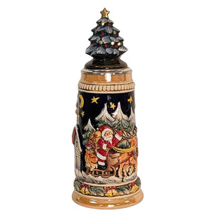 German beer stein with Santa sleigh scene, reindeer, snowy forest, and ceramic Christmas tree lid topped with a golden star.

