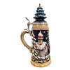 side of German beer stein with Santa sleigh scene, reindeer, snowy forest,snow covered church, and ceramic Christmas tree lid topped with a golden star.