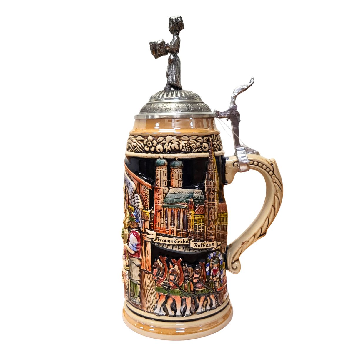 side of 1-liter German Oktoberfest beer stein with Frauenkirche, Rathaus, and horse-drawn wagon transporting beer kegs, and pewter lid topped with waitress holding 10 beer mugs.