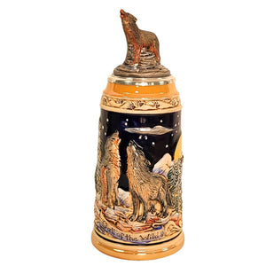 Wolf-themed German beer stein with sculpted wolves, snowy forest, full moon, and pewter lid topped with a hand-painted wolf figurine.
