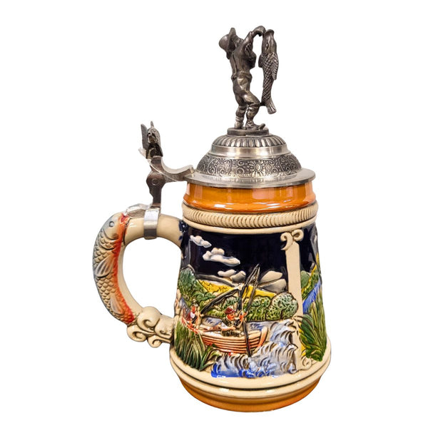 the side of a German beer stein with hand-painted fishing scene, fish-shaped handle, fish thumb lift, and pewter lid topped with a fisherman holding a catch.

