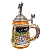 the side of a German beer stein with hand-painted fishing scene, fish-shaped handle, fish thumb lift, and pewter lid topped with a fisherman holding a catch.
