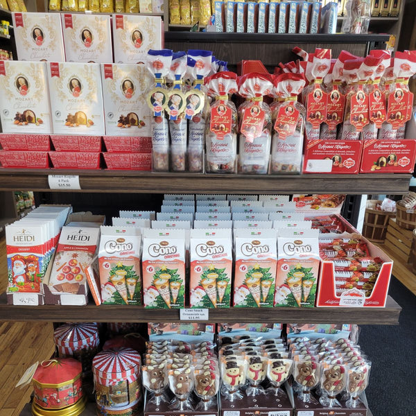 Shelf with various food products including boxes and packets in a store setting.