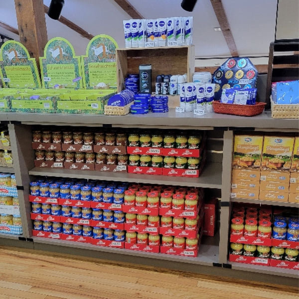 Shelf stocked with various food products in a store setting
