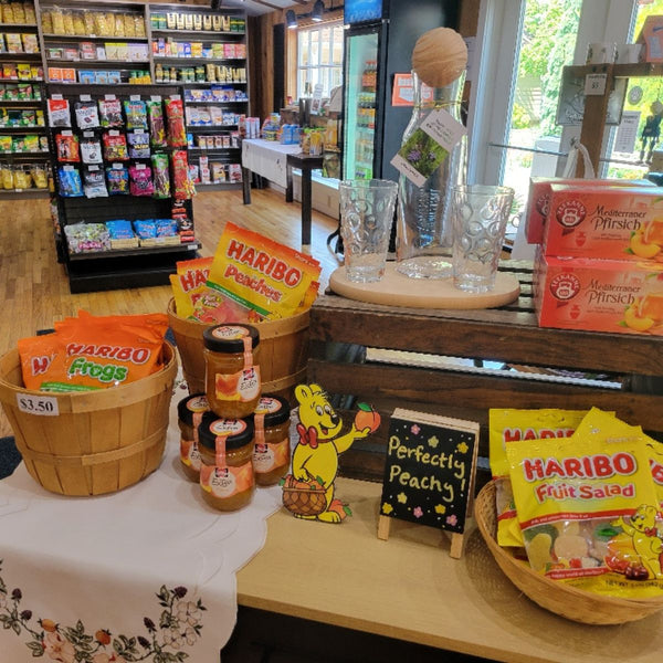 Display of peach flavored Haribo candy and other snacks in a store setting