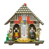 Weather house with musicians to the right and left of the Bavarian couple. 2 traditional musical instruments are shown, which also play an important role at the Oktoberfest. An accordion and a tuba. A thermometer hangs between the couple.