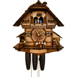 8-Day Schneider Chalet Coocoo clock with music. The timbered chalet clock has a lighter colored natural wood lower section, the upper section is made of darker wood. Two men sitting on chairs are drinking beer at a table underneath the dial. There is a man rolling barrels on the left and a keg tapper on the right. The windows feature Bavarian blue and white curtains and the dancers spin on an ornately carved balcony. There is a sign saying “Brauhaus” – “Brewery” underneath the base of the clock.