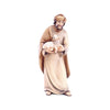 Sculpted wooden Shepherd figurine for Artis Nativity set. He is dressed in white and tan robes, wearing a turban, and holding a lamb in his arms.