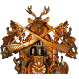 Detail of the upper attachment of the August Schwer cuckoo clock with the two guns, the leaves and the deer head with antlers.