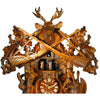 Detail of the upper attachment of the August Schwer cuckoo clock with the two guns, the leaves and the deer head with antlers.