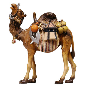 The PEMA Kostner Nativity is a beautifully crafted nativity set that includes an intricately designed standing camel with ornate head gear and a saddle pack with intricate details and extensive luggage. The camel has the head lifted up with its mouth slightly open. Create a timeless holiday display with this classic set, perfect for a festive holiday decoration.