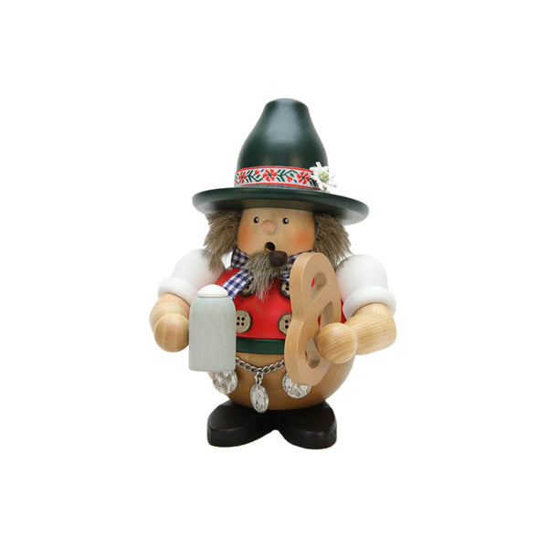 This Ulbricht Smoker is right from the Oktoberfest. in his traditional clothes he is holding a pretzel and a beer mug in his hands.