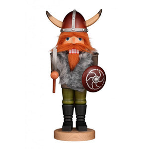 Christian Ubricht nutcracker Viking with red hair, red beard and an imposing Viking helmet. In one hand he holds an axe and in the other a shield. A gray field jacket keeps him warm.