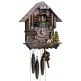 1-Day Schneider Chalet CooCoo clock with a man chopping wood on the right with an evergreen tree. There is a pile of wood and a waterwheel underneath a little roof on the left. Above the dial in the middle is a balcony where dancers are dancing with the music on the full and half hour. The dark stain of the wood accentuates the lighter colored clock hands and number. There are flower accents on the wood paneling and a smooth roof.