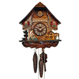 1-Day Schneider Chalet Coo Coo Clock with a blacksmith dressed in a red vest working his forge on the left. On the right, there is a horse in a paddock watching. The dial sits in the middle and is flanked by upper windows with red shutters and window boxes with flowers underneath. The coockoo door above the balcony is carved with the A(nton) S(chneider) initials. The wooden paneling and balcony feature a lighter colored decorative edge.