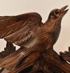 A carved Cuckoo Bird poised as if about to take flight on a Schneider Traditional Cuckoo Clock