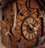 The Dial of a Schneider Black Forest Cuckoo Clock with roman numerals framed with Ivy Vines 