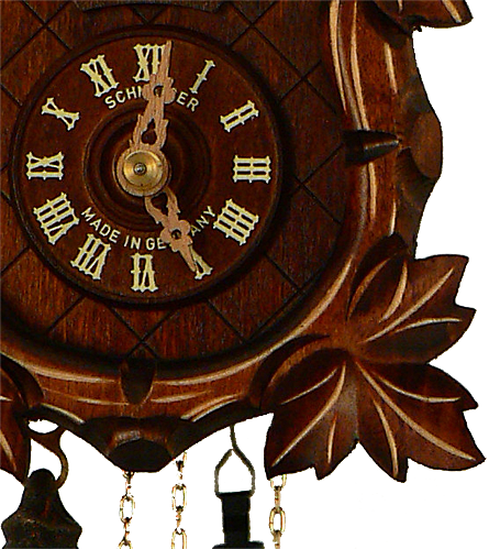 Close up of a  detailed Grape Leaf next to the Dial on a Schneider Traditional Black Forest Cuckoo Clock