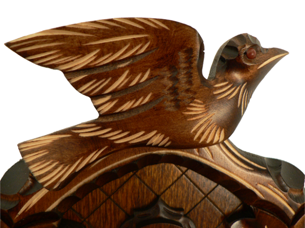 A detailed carved Bird with spread Wings on Top of a Schneider Traditional Black Forest Cuckoo Clock