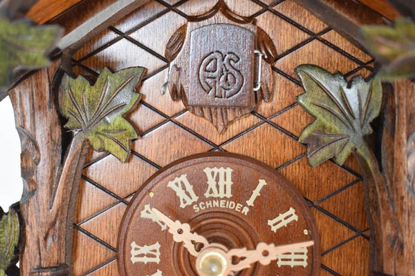 Cuckoo Door with AS the initials for Anton Schneider framed by Green Leaves Traditional Cuckoo Clock