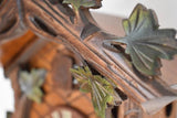 Close up of the hand carved green Leaves on a Schneider Traditional Black Forest Cuckoo Clock