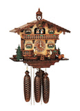8-Day Schneider Black Forest Chalet Coocoo clock with music. The natural-colored wooden clock face has two darker stained balcony fences on each side with evergreen trees, and two barrels on the right. Two men dressed in Bavarian Lederhosen are holding their beer steins while sitting on a teeter-totter. There are two sets of windows with shutters on both levels, and a wide ornately carved balcony on the 2nd floor. The cuckoo comes out above the dancers and there is a bell tower on the roof.