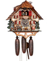 8-Day Black Forest Chalet Schneider coocoo clock with music. The chalet is white with curved brown timbers. A green fir tree sits on each side. A water wheel spins on the left, two men are sitting at a table drinking beer underneath the dial and a waitress is carrying more beer steins on the right. A pile of wood and stones sit on the right corner. The windows have red shutters and flower boxes underneath. Dancers spin above an ornate balcony. The roof has shingles.