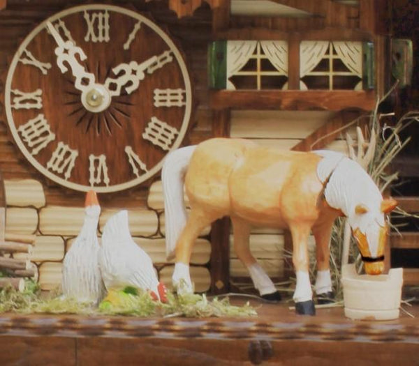 Detail of Rombach & Haas 8-Day Cuckoo Clock showing a goose looking at the dial, a chicken pecking at the grass, and a horse with its head over a bucket