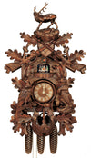 8-Day Traditional Black Forest Hunter coocoo clock. The solid wood traditional style clock features a rabbit on his hind legs on the right edge of the clock and a pheasant looking up on the left edge. The front is decorated with oak leaves. A hunter’s pouch is featured at the bottom. A horn encircles the dial. Dancers spin on a balcony underneath the cuckoo bird. The roaring stag stands above the crossed rifles at the top of the clock. 