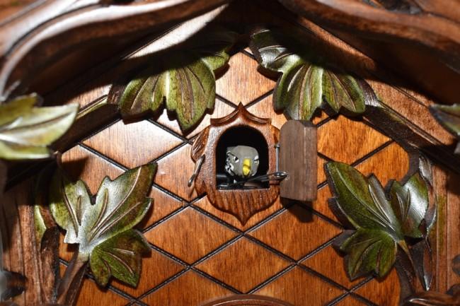 Cuckoo Bird looking out of his door surrounded by Ivy Leaves on a Traditional Schneider Cuckoo Clock