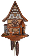 8-Day Black Forest Chalet coocoo clock. The half-timbered cuckoo clock has darker wood in the lower part of the clock and white stucco on the upper half of the clock. The dial is dark brown. A traveler with a dog comes through an arch on the left, 2 beer drinkers are sitting at a table. A cat sits on a bench underneath windows and on the left, a watchman holding a lantern and a halberd comes out a little turret on the right. The steep roof complements the Tudor style house.