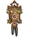 8-Day Black Forest Traditional coocoo clock. The front face has diamond shaped gridlines. Carved brown wooden leaves and smaller green ivy leaves decorate the edge of the clock. One colorful bird sits on the lower right corner of the clock, another one on the left upper corner. The third colorful bird looks out a little carved nest at the very top of the clock and is surrounded by carved ivy leaves.