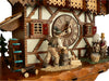 Man chopping Wood and a Woman sitting at her Spinning Wheel on a Schneider Black Forest Cuckoo Clock