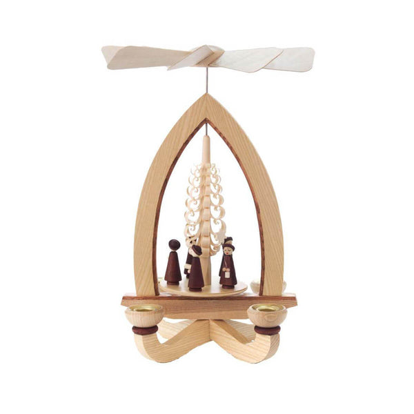 This pyramid features a single tier design with a meticulously made natural Christmas tree out of delicate curved wood shavings. The Carolers are dressed in dark brown robes wearing brown hats and sing holding their hymnals. There are four candle holders and the candles will make the pyramid spin and bring joy to every home.