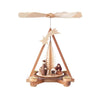 This pyramid features a single tier design with a meticulously made natural Christmas tree out of delicate curved wood shavings. There is a large shooting star on top. The nativity scene depicts a standing Joseph and kneeling Mary watching Jesus lying in the manger. Sheep complement the nativity scene. 
