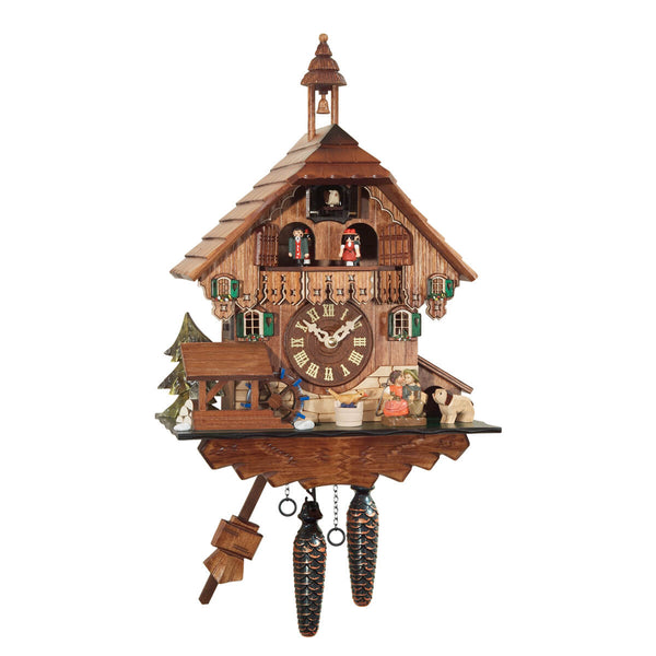 This battery-operated cuckoo clock creates a charming atmosphere with its lovely bell tower and unique light brown stain. A delightful scene unfolds, featuring a kissing couple sitting on a bench, a playful puppy dog and a melodious songbird watching over them. The mill wheel turns, and the dancers up on the balcony twirl joyfully. This bell tower on the roof adds another charming feature to this hand-carved Black Forest cuckoo clock.