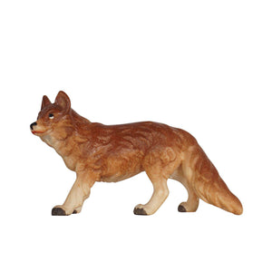 This PEMA Kostner Nativity fox is a handcarved wooden figurine of a fox standing looking up to the left, with realistic brown coloring and a bushy tail. This beautiful piece is sure to add captivating detail and charm to your décor and perfect for animal lovers.
