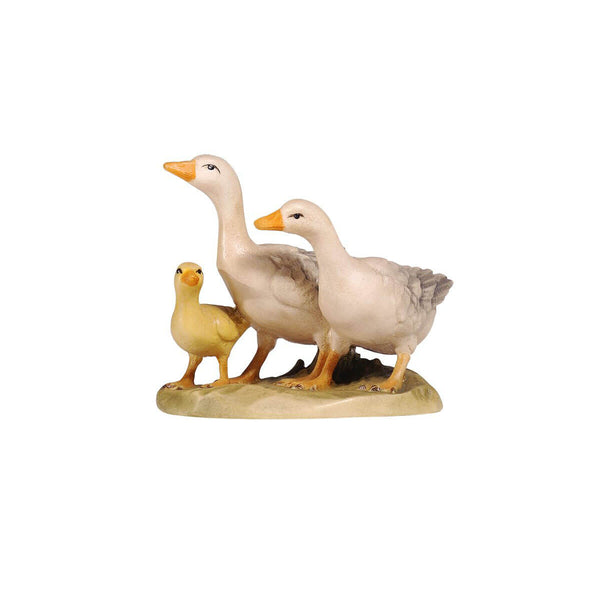 The PEMA Kostner Nativity - Group Of Geese is a hand-carved wooden replica, featuring three geese of varying sizes and an intricate design. Its unique design includes the largest goose in the middle, a smaller goose on one side, and a little baby goose looking up on the other side. Each piece has been hand-painted for a detailed finish.