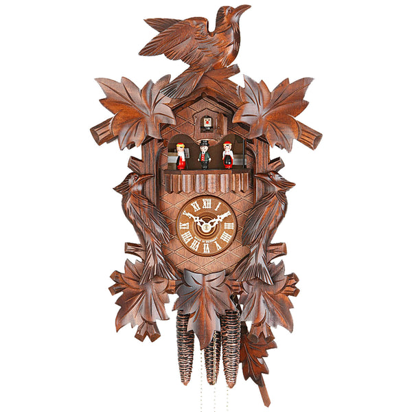 Ornate carved Leaves and Birds frame the Dial and Black Forest Dancers on a Hekas Traditional Cuckoo Clock