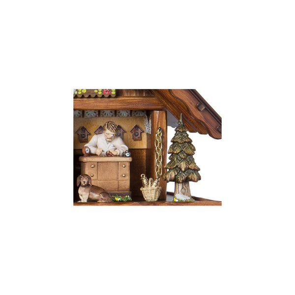 Zoomed in view of the Clockmaker featured under the lights, on the right side of the clock