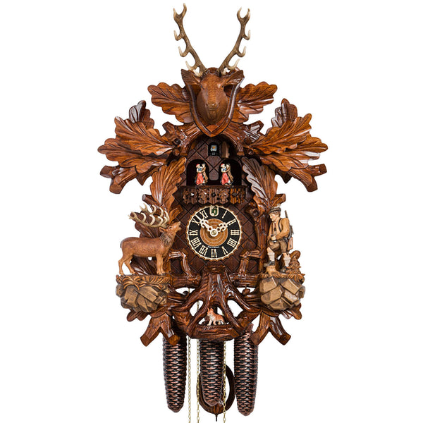 Painted 8-Day Cuckoo Clock featuring a detailed hunter raising binoculars to observe a majestic stag. Below, charming dancers in traditional Black Forest attire spin on the balcony. The clock is adorned with an impressive stag's head at the top and a hidden fox beneath the dial.