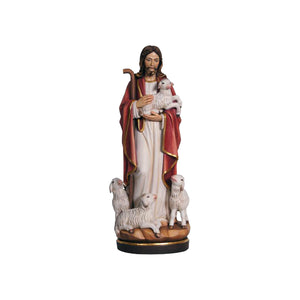 Wooden statue of Jesus, holding a shepherd's cook and a lamb in his arms, with several lambs around his feet.