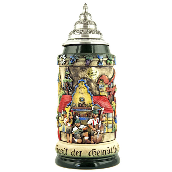 King Beer stein with  a Traditional Oktoberfest Band playing music, in front of one of the Oktoberfest buildings with a festively decorated tree.