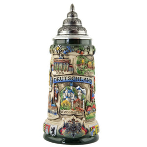 King Beer stein with a pewte Lid. There is a banner with "Deutschland" written on it and the cities Berlin and Heidelberg plus Neuschwanstein. On the bottom rim is the German Eagle with two flags.