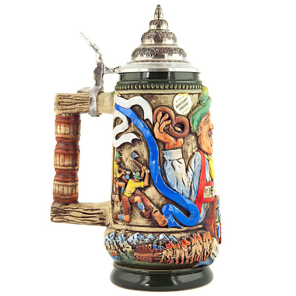 King beer stein with  men working a tree trunk with axes underneath the Alps and a  beer wagon pulled by horses. A nice detail is the handle that looks like Beer Kegs.
