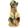 Beer Stein in the shape of a police dog. The shepherd dog wears a typical green German police uniform and holds a stack of books in his paw