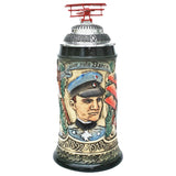 Bier Stein with the portrait of Manfred von Richthofen. (the red baron). There is a  a model of his plane on top of the lid.