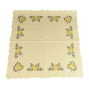 Square white tablecloth with a border of flower bouquets, and a white stitching design in the center.